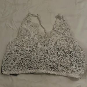 Adorable crop top! Great condition. White lace in front, blue floral tie in back